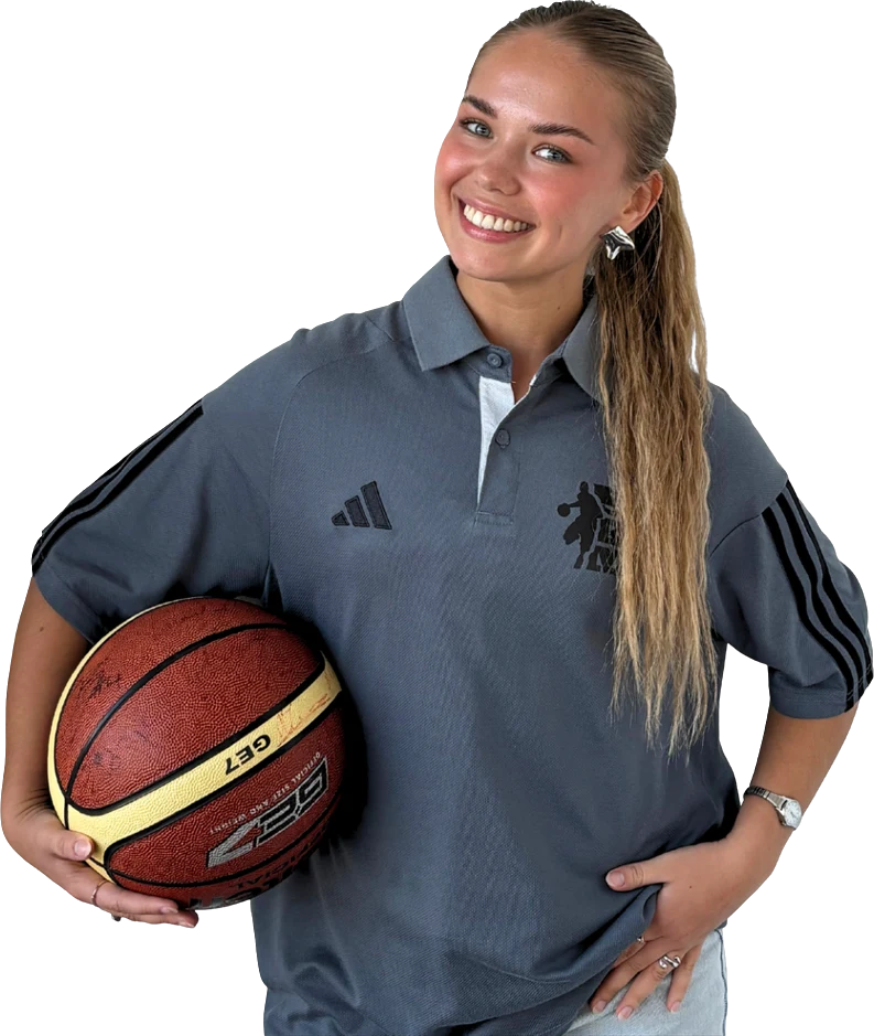 Kamilė in an SKM polo holding a basketball